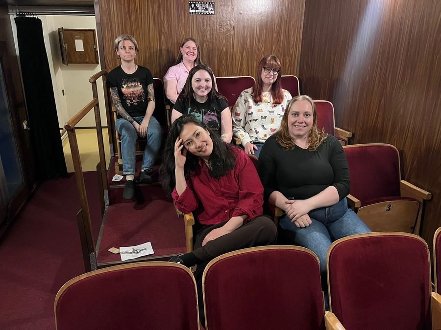 Kino Klub group photo in a vintage cinema screening room