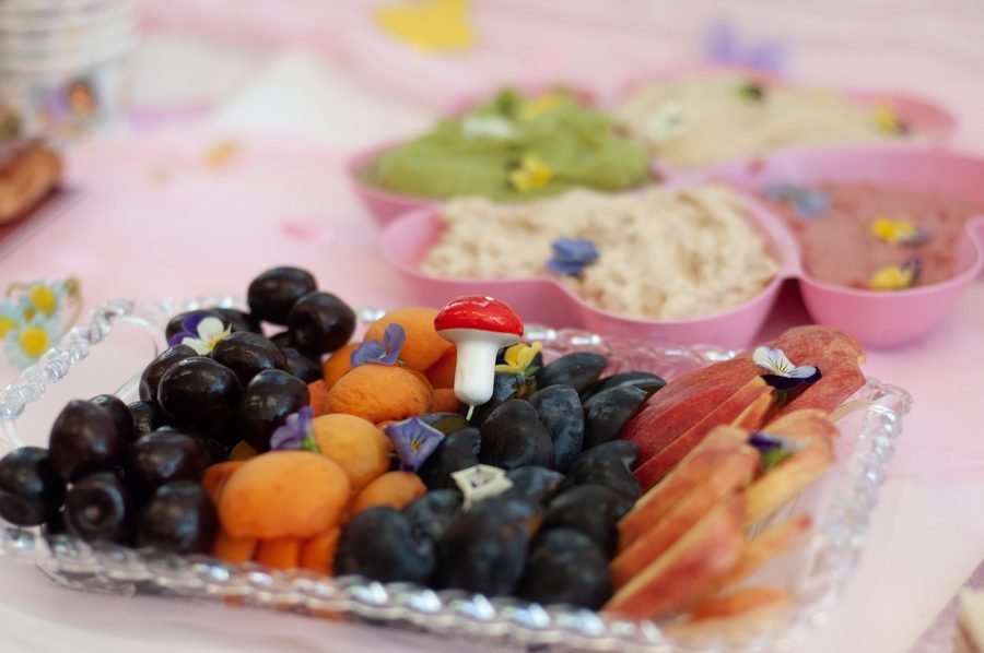 Whimsical fairytale-themed snack board with edible flowers